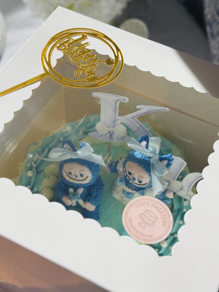 Vintage Labubu inspired cake with cakepop fondant figurines. 